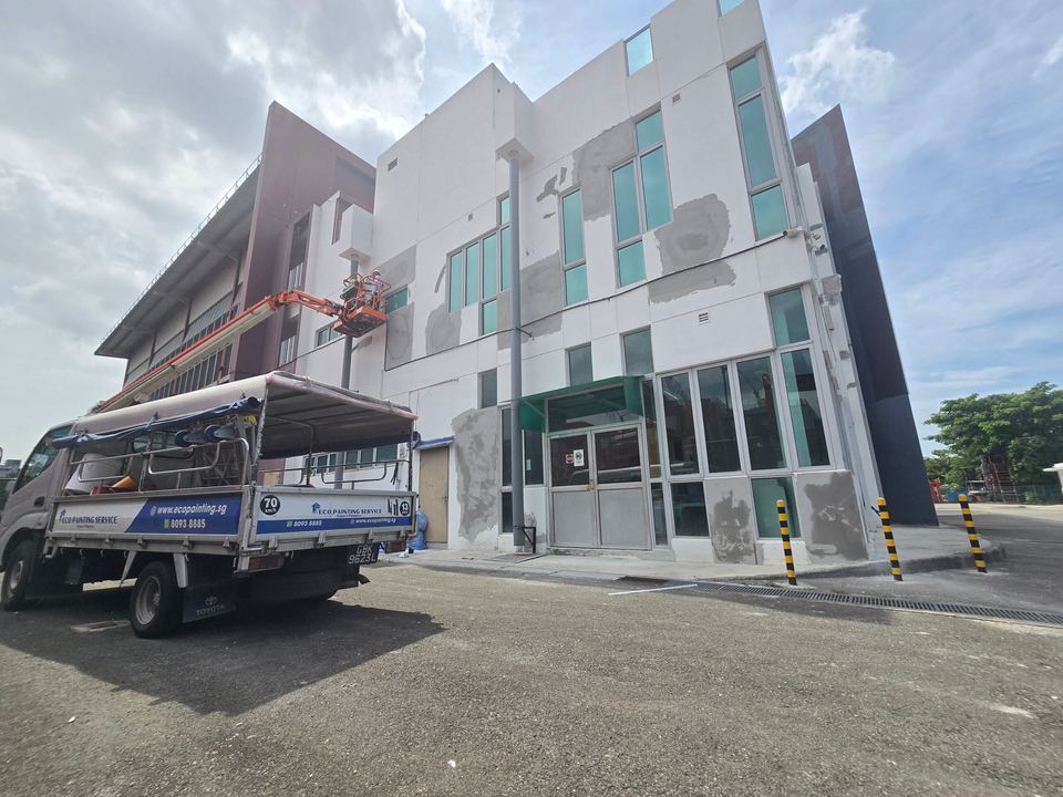 Eco Painting Service lorry and an orange boom lift on a commercial repainting job in Singapore