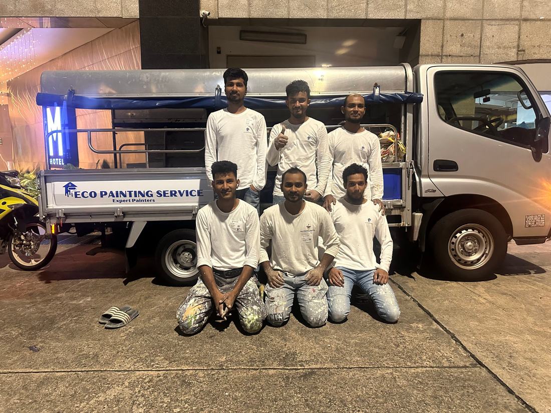 Six Eco Painting Service team leaders in company shirts standing with the company lorry in Singapore